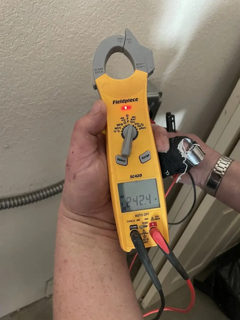 Voltage testing with clamp meter during Recessed Lighting Installation in West Warwick